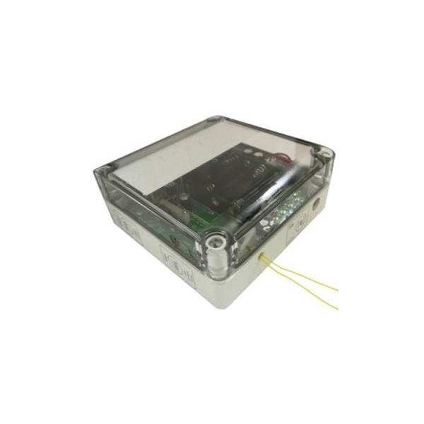 Weißes, rechteckiges Elektronikgehäuse mit transparentem Deckel, der eine grüne Leiterplatte mit schwarzen Komponenten und Batterien zeigt. Seitlich ragen zwei dünne gelbe Kabel heraus. Schräg von oben auf weißer Fläche.